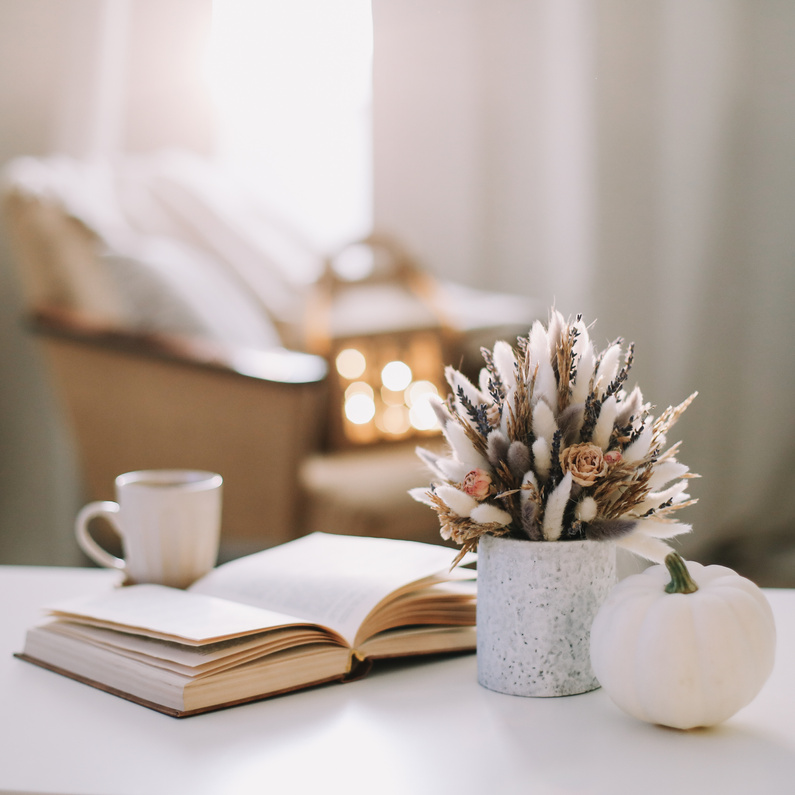 Autumn still life. Coffee cup, flowers, book and pumpkin. Hygge lifestyle, cozy autumn mood. Flat lay, Happy thanksgiving